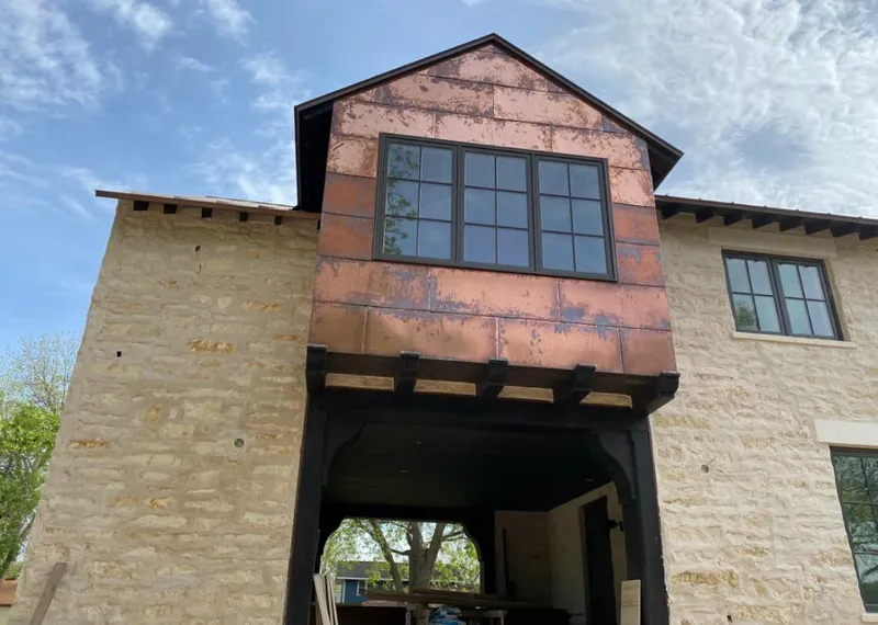 Copper metal panel facade on a stone building for Metal Roof Coating in Mapleton