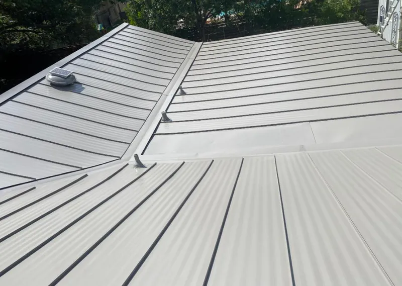 Solar attic fan installed on a metal roof for Roof Ventilation in Mapleton
